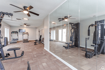 A spacious home gym with a variety of equipment.